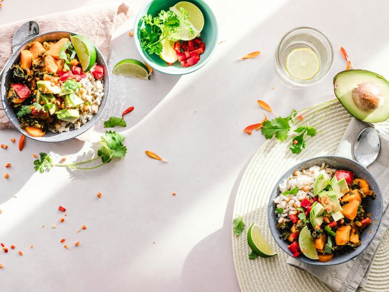 top-down view of vibrant vegan bowls filled with fresh vegetables, per image